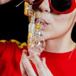 A close-up, angled view shows the Orbit Mini Rig 4-Piece Kit held against a vibrant red background.