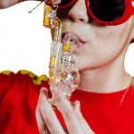 Close-up, front view of the Orbit Mini Rig 4-Piece Kit held in a hand, showcasing its compact size and clear glass construction.