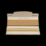 Pack of beige rolling papers with “ASH” branding and website address on a white background.