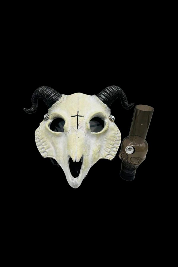 Goat skull with a glass oil rig inside its mouth, featuring a cross on its forehead, against a black background.