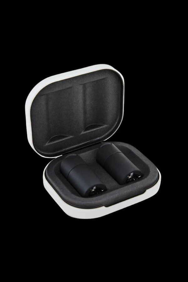 Open white and black carrying case with two cannabis vape pen cartridges inside.