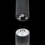 Black cannabis vaporizer pen shown with both ends exposed, one displaying the atomizer and the other the charging port.
