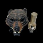 Bear-shaped cannabis water pipe with a metallic rig attached, set against a black background.