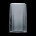 Ribbed glass smoking pipe against a black background.