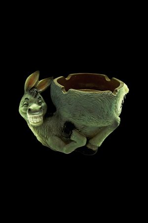 Ceramic donkey ashtray with a textured green finish, isolated on a black background.
