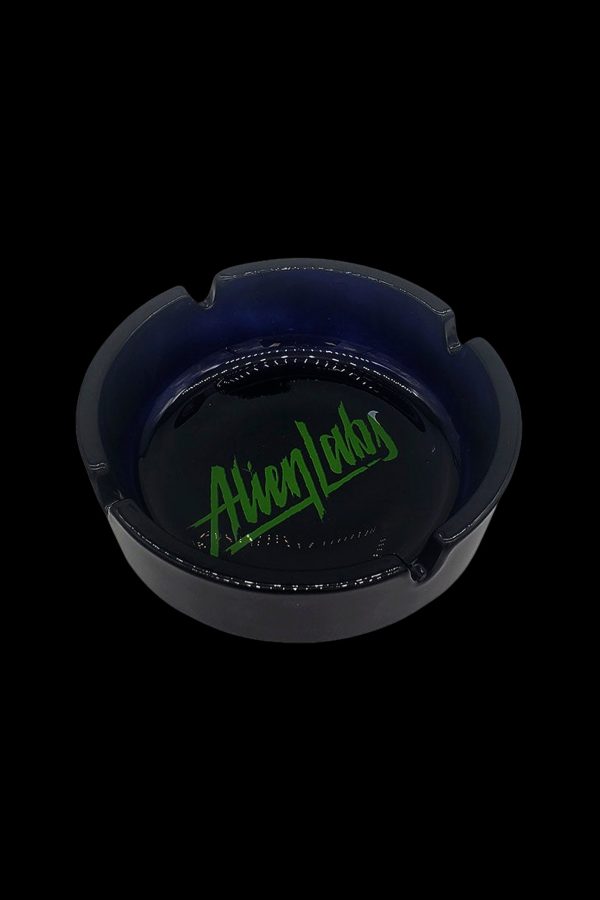 Black glass ashtray with green “Alien Labs” logo.