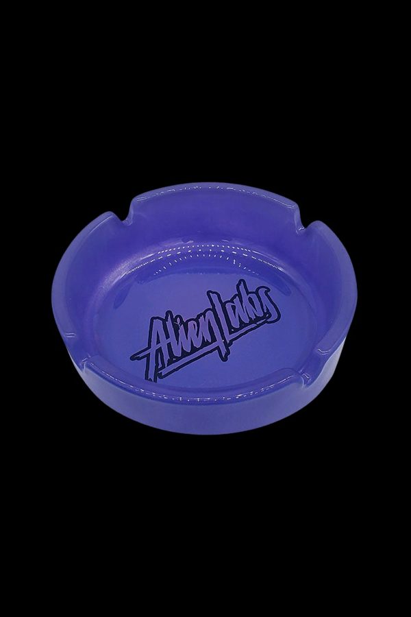 Blue glass ashtray with “Alien Labs” logo.