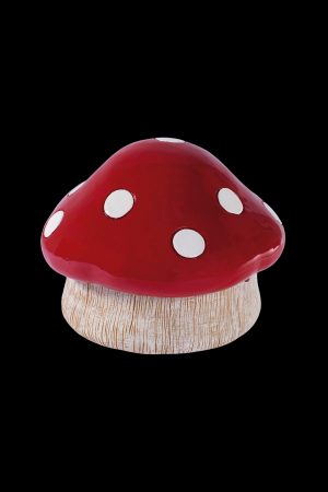 Red and white spotted mushroom-shaped cannabis storage container.