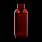 Amber glass cannabis oil vial with a unique hourglass-shaped stopper, isolated on a black background.