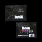 Black retail bag for “The Base” cannabis accessory, displaying color options and website information.