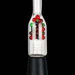 Glass bubbler water pipe with red and green accents, displayed on a black stand.