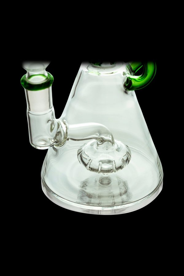 Clear glass water pipe (bong) with a complex percolator and green accents, isolated on a black background.