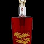 Ornate red glass cannabis oil vial with gold detailing.