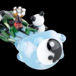 Hand-blown glass water pipe shaped like a panda relaxing in a yin-yang bubble bath, surrounded by colorful floral accents.