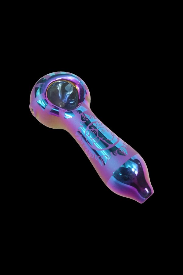 Iridescent glass smoking pipe with floral etching against a black background.