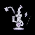 Clear glass dab rig with purple accents, including a quartz banger, carb cap, and dab tool, displayed against a black background.
