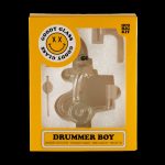 A yellow box for “Goody Glass” branded “Drummer Boy” mini rig kit, featuring a graphic of a small oil rig resembling a drum set and text listing included items: mini barrel recycler rig, 10mm quartz banger, bubble carb cap, and mini dab tool.