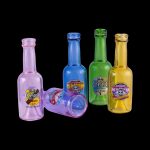 Colorful glass oil bottles and a shot glass with cannabis-themed branding against a black background.