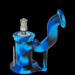 Blue glass oil rig with titanium tip, isolated on a black background.
