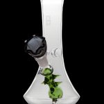 Clear glass bong with green sculpted accents and a black mouthpiece, isolated on a black background.