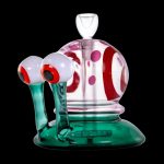 A colorful glass water pipe shaped like a cartoonish monster with large eyes.