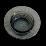 Overhead view of a clear glass ashtray with a patterned base, likely for cannabis use.