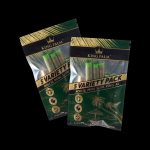 Two sealed packages of King Palm 5 Variety Packs rolling papers on a black background.