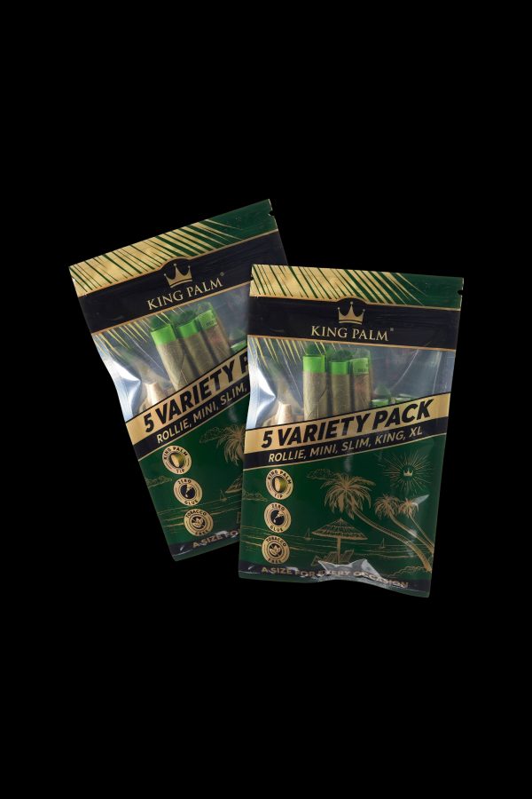Two sealed packages of King Palm 5 Variety Packs rolling papers on a black background.