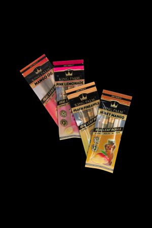 A stack of colorful King Palm pre-rolled leaf wraps in various fruit flavors like mango, peach pineapple, and pink lemonade, displayed against a black background.