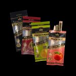 Assortment of colorful King Palm pre-rolled cones and packaging, including flavors like gelato, cherry, and peach, against a dark background.