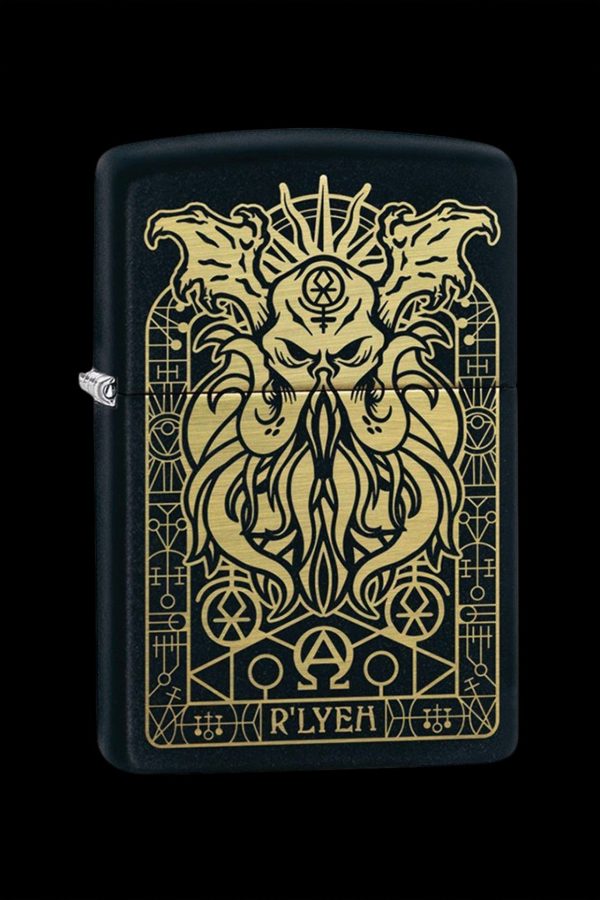 Gold-toned Cthulhu-inspired lighter with intricate, occult-style border and “R’LYEH” inscription on a black background.