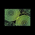 Glowing green mandala pattern with crystal shapes on a black background.