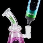Ooze vaporizer pen connected to a glass water pipe.