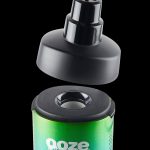 Green and black cannabis concentrate container with removable lid.