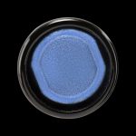 Blue cannabis concentrate in a small glass jar.