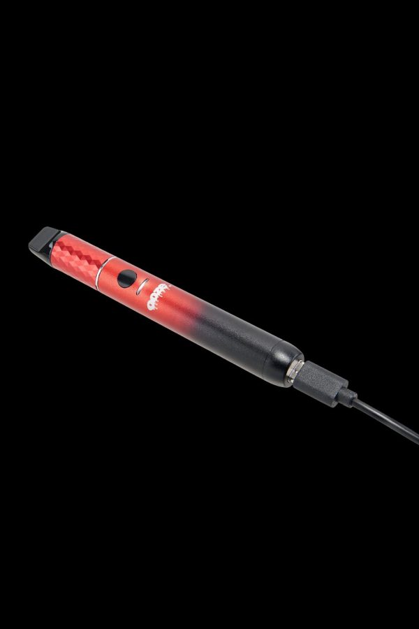 Red and black cannabis dab pen on a black background.