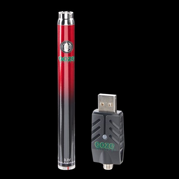 Red and black cannabis vape pen with USB charger.