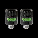 Two black glass cartridges with the “Ooze” logo in green, displayed against a black background.
