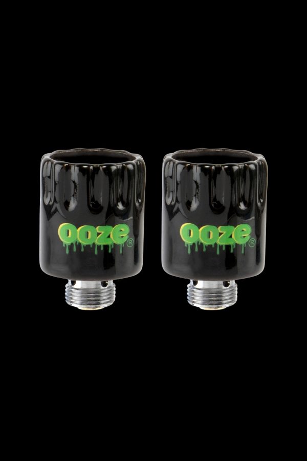 Two black glass cartridges with the “Ooze” logo in green, displayed against a black background.