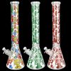 Three glass bongs with colorful mushroom designs against a black background.