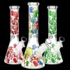 Three glass bongs decorated with colorful mushroom designs against a black background.