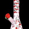 Pink glass bong decorated with red cherries against a black background.