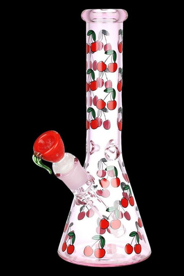 Pink glass bong decorated with red cherries against a black background.