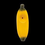 Yellow glass banana-shaped smoking pipe with a smiling face on a black background.