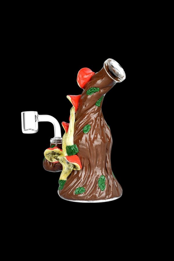 Hand-blown glass rig shaped like a tree with colorful mushrooms, featuring a quartz banger for cannabis concentrates.