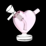 Pink heart-shaped glass bubbler for smoking, with a bowl and mouthpiece.