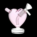 Pink glass heart-shaped bubbler for cannabis use.