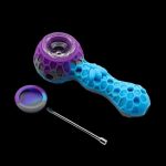 Blue and purple silicone smoking pipe with a metal pick and collection dish on a black background.