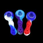 Colorful silicone smoking pipes against a black background.