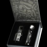 Open black box displaying a cannabis oil burner and accessories, branded with "#ENJOYHIGHERCULTURE".